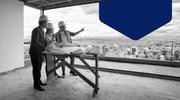 Three individuals overview the details of a construction project, which can differ based on if it is a commercial real estate vs. residential real estate project.